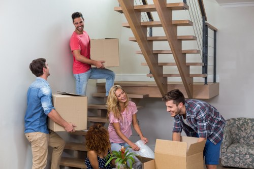 Careful packing materials and wrapped furniture prepared for a flat move in St Johns Wood