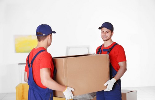 Commercial moving team handling desks and equipment for a local office move