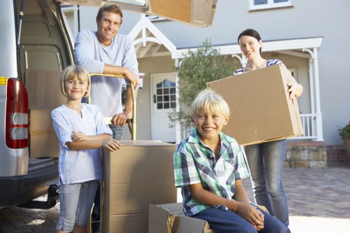Professional movers handling furniture and boxes in a St Johns Wood home