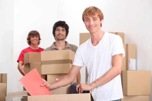 Furniture and boxes being loaded into a moving van for a NW8 collection